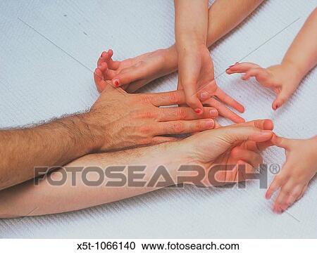 Family hands six hands father mother and daughter on white background View Large Photo Image Stock Image - Family hands six hands father mother and daughter on white background. Fotosearch
