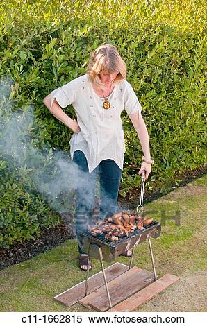 Stock Photography - family having barbeque in garden, blackpool, england, uk, europe. Fotosearch