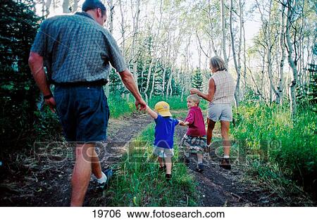 Stock Photograph - Family hiking in woods. Fotosearch