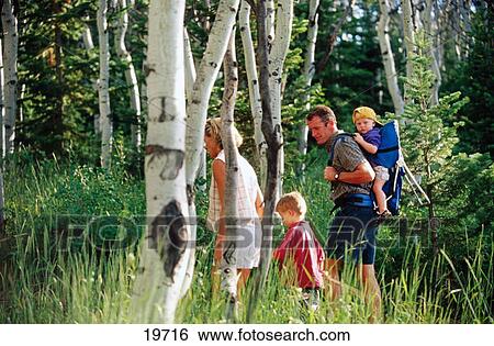Stock Photograph - Family hiking in woods. Fotosearch