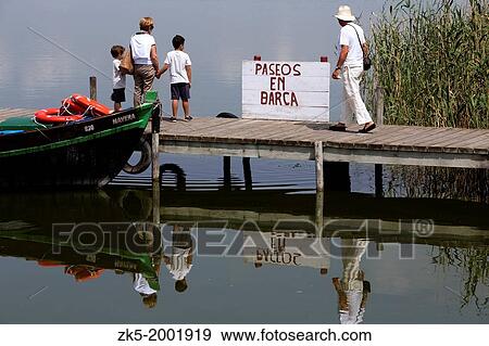 Stock Photo - Family in a albuferenc, boat ride on the Albufera of Valencia.. Fotosearch