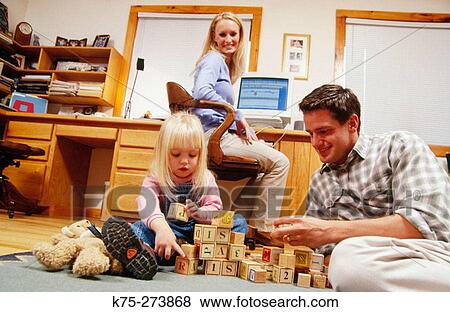 Family in home office View Large Photo Image Stock Photo - Family in home office. Fotosearch