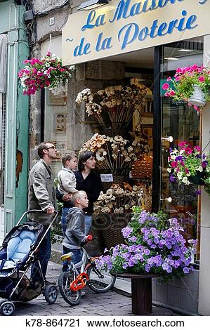 Family looking at a flower shop in the old town of Dinan, Brittany, France View Large Photo Image Stock Image - Family looking at a flower shop in the old town of Dinan, Brittany, France. Fotosearch