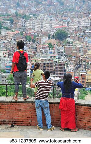 Stock Photography - Family looking at Kathmandu city from Swayambhunath temple, Nepal.. Fotosearch