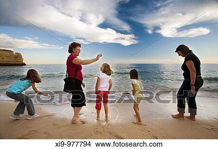 Family members enjyoing a beach, town of Porches, municipality of Lagoa, district of Faro, region of Algarve, Portugal View Large Photo Image Picture - Family members enjyoing a beach, town of Porches, municipality of Lagoa, district of Faro, region of Algarve, Portugal. Fotosearch