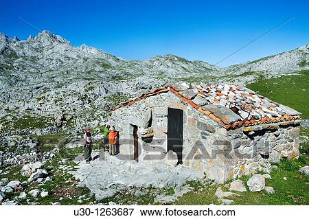Family next to shepherds huts in Vega de Ario, near Marqu's de Villaviciosa Hut, in honor of Mr Pedro Pidal y Bernardo de Quir? s, known as Vega de Ario Hut, in the Corni? n massif, in Picos de Europa National Park, Asturias, Spain View Large Photo Image Stock Photo - Family next to shepherds huts in Vega de Ario, near Marqu's de Villaviciosa Hut, in honor of Mr Pedro Pidal y Bernardo de Quir? s, known as Vega de Ario Hut, in the Corni? n massif, in Picos de Europa National Park, Asturias, Spain. Fotosearch