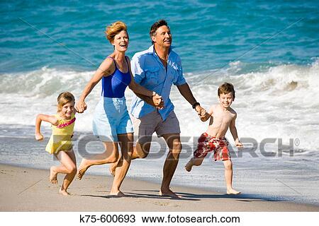 Family of 4 walking on beach View Large Photo Image Stock Image - Family of 4 walking on beach. Fotosearch