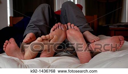 Family of four in bed together. View Large Photo Image Stock Photo - Family of four in bed together.. Fotosearch