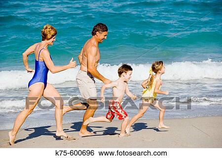 Family of four running on beach View Large Photo Image Stock Photograph - Family of four running on beach. Fotosearch