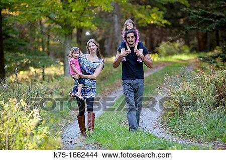 Family of four walking down country road View Large Photo Image Picture - Family of four walking down country road. Fotosearch