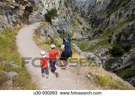 Family of hikers walking along the route of the Cares Canyon, in the Picos de Europa National Park, between the Urrieles and? ndara massifs, Poncebos, Cantabria, Spain View Large Photo Image Stock Image - Family of hikers walking along the route of the Cares Canyon, in the Picos de Europa National Park, between the Urrieles and? ndara massifs, Poncebos, Cantabria, Spain. Fotosearch