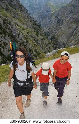 Stock Photo - Family of hikers walking along the route of the Cares Canyon, in the Picos de Europa National Park, between the Urrieles and? ndara massifs, Poncebos, Cantabria, Spain. Fotosearch