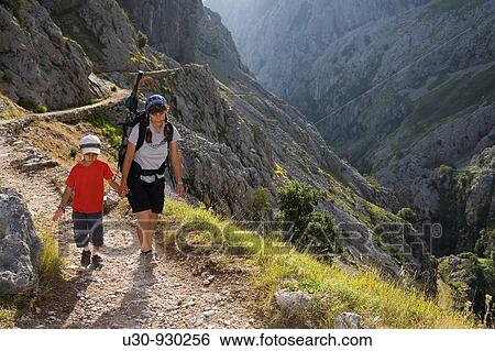 Family of hikers walking along the route of the Cares Canyon, in the Picos de Europa National Park, between the Urrieles and? ndara massifs, Poncebos, Cantabria, Spain View Large Photo Image Stock Photograph - Family of hikers walking along the route of the Cares Canyon, in the Picos de Europa National Park, between the Urrieles and? ndara massifs, Poncebos, Cantabria, Spain. Fotosearch