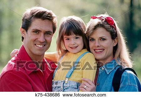 Stock Photograph - family of three portrait outdoors. Fotosearch