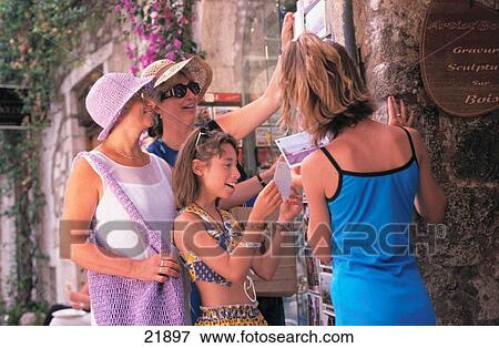 Family of visitors buying postcards. St. Paul de Vence. France View Large Photo Image Stock Photo - Family of visitors buying postcards. St. Paul de Vence. France. Fotosearch