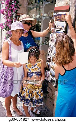 Family of visitors buying postcards. St. Paul de Vence. France View Large Photo Image Stock Photo - Family of visitors buying postcards. St. Paul de Vence. France. Fotosearch