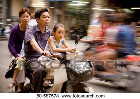 Family on a motorbike. Ho Chi Minh City. Vietnam. View Large Photo Image Stock Photo - Family on a motorbike. Ho Chi Minh City. Vietnam.. Fotosearch