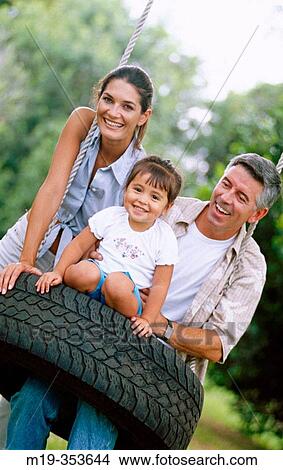 Picture - family on a swing. Fotosearch