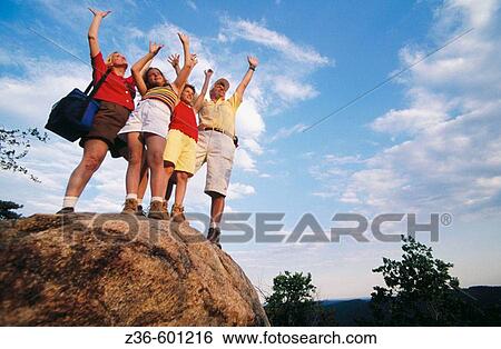 Stock Photograph - Family on a top of the mountain. Fotosearch
