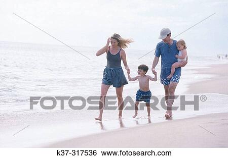 Family on beach. Parents with son and daughter leaving footprints in the sand, nuclear family, Nantucket, Massachusetts, USA View Large Photo Image Stock Photograph - Family on beach. Parents with son and daughter leaving footprints in the sand, nuclear family, Nantucket, Massachusetts, USA. Fotosearch