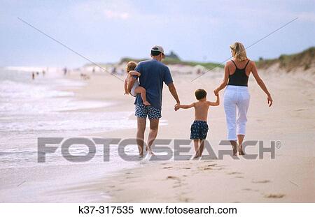 Stock Photography - Family on beach. Parents with son and daughter leaving footprints in the sand, nuclear family, Nantucket, Massachusetts, USA. Fotosearch