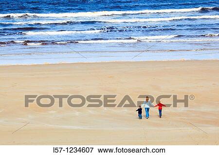 Stock Photo - family on sandy beach, Sutherland, Scotland. Fotosearch