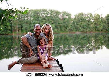 Family on the pier in Lake Avral, Kirillovka, Samara Region, Russian Federation View Large Photo Image Stock Photograph - Family on the pier in Lake Avral, Kirillovka, Samara Region, Russian Federation. Fotosearch