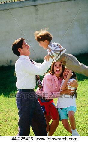 Stock Photograph - Family playing in the garden. Fotosearch