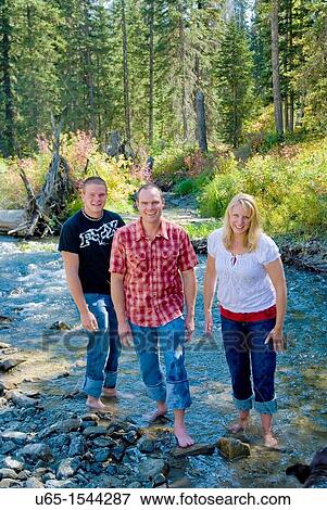 Family playing in the river View Large Photo Image Stock Photo - Family playing in the river. Fotosearch