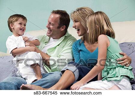 Family playing on floor in front of couch View Large Photo Image Stock Photography - Family playing on floor in front of couch. Fotosearch
