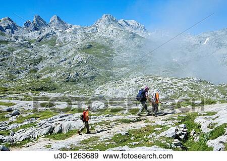 Stock Photo - Family practice mountaineering, in Vega de Ario, next to Marqu's de Villaviciosa Hut, in honor of Mr Pedro Pidal y Bernardo de Quir? s, known as Vega de Ario Hut, in the Corni? n massif, in Picos de Europa National Park, Asturias, Spain. Fotosearch
