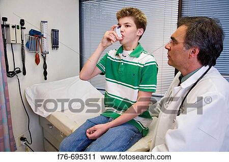 Family practice physician, doctor, pediatrician instructing 14 year old boy in the proper use of an inhaler for the treatment of his asthma, during a physical exam View Large Photo Image Stock Image - Family practice physician, doctor, pediatrician instructing 14 year old boy in the proper use of an inhaler for the treatment of his asthma, during a physical exam. Fotosearch