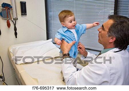 Family practice physician, doctor, pediatrician examining 8 month old child View Large Photo Image Stock Photo - Family practice physician, doctor, pediatrician examining 8 month old child. Fotosearch