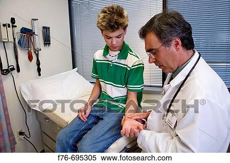 Family practice physician, doctor, pediatrician checking the pulse and circulation of 14 year old boy during a physical exam View Large Photo Image Stock Photography - Family practice physician, doctor, pediatrician checking the pulse and circulation of 14 year old boy during a physical exam. Fotosearch