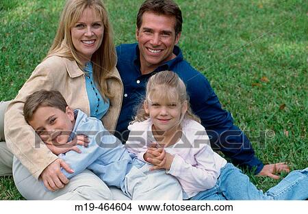 family relaxing on the grass View Large Photo Image Picture - family relaxing on the grass. Fotosearch