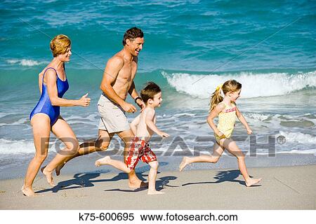 Family running on beach View Large Photo Image Stock Photography - Family running on beach. Fotosearch