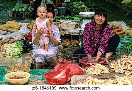 Family selling food at a market near the Li River in Guilin China View Large Photo Image Stock Photo - Family selling food at a market near the Li River in Guilin China. Fotosearch