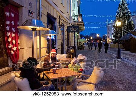 Family Sitting in Street Cafe Suudlevad Tundengid, Christmas, Winter, Tartu, Estonia View Large Photo Image Stock Image - Family Sitting in Street Cafe Suudlevad Tundengid, Christmas, Winter, Tartu, Estonia. Fotosearch