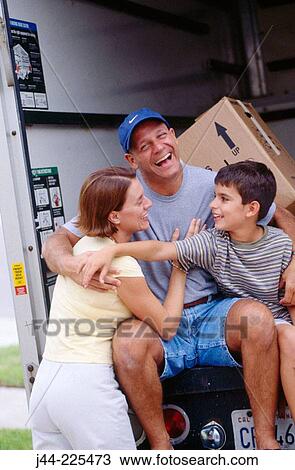 Stock Image - Family sitting on moving truck deck. Fotosearch