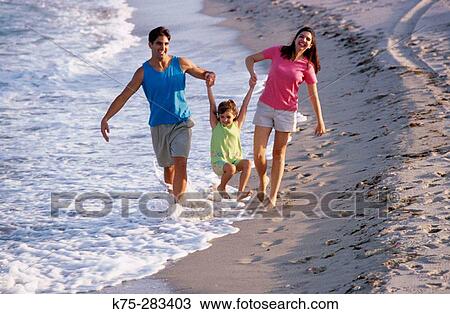 family strolling at beach View Large Photo Image Stock Image - family strolling at beach. Fotosearch
