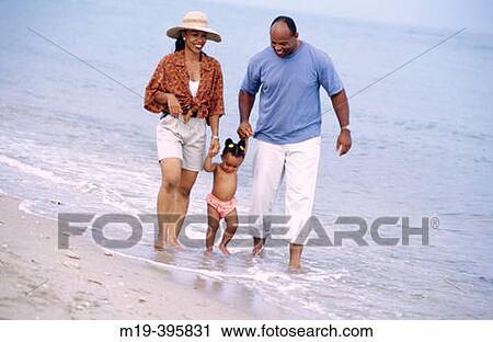 family strolling on the beach View Large Photo Image Stock Image - family strolling on the beach. Fotosearch