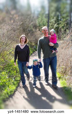 Family taking a walk in the woods View Large Photo Image Stock Image - Family taking a walk in the woods. Fotosearch