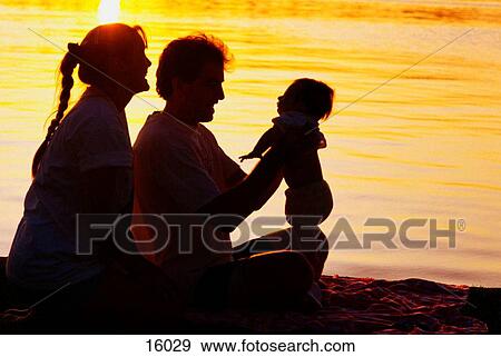 Stock Photo - Family together at sunset. Fotosearch