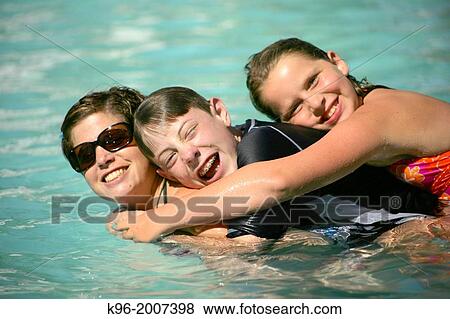 Stock Photo - Family together in pool. Fotosearch