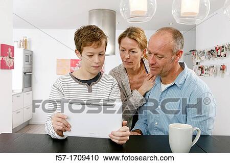 Family using tablet computer at home View Large Photo Image Stock Image - Family using tablet computer at home. Fotosearch