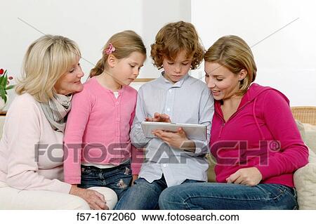 Family using tablet computer View Large Photo Image Stock Image - Family using tablet computer. Fotosearch