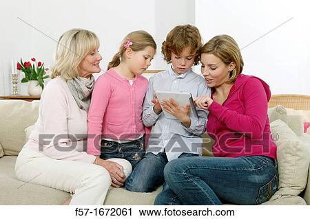 Stock Image - Family using tablet computer. Fotosearch