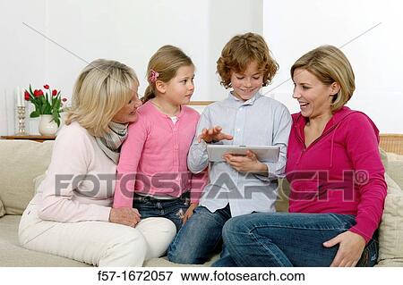 Family using tablet computer View Large Photo Image Stock Photo - Family using tablet computer. Fotosearch