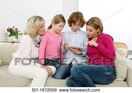 Family using tablet computer View Large Photo Image Stock Photo - Family using tablet computer. Fotosearch