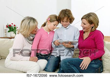 Family using tablet computer View Large Photo Image Stock Photograph - Family using tablet computer. Fotosearch